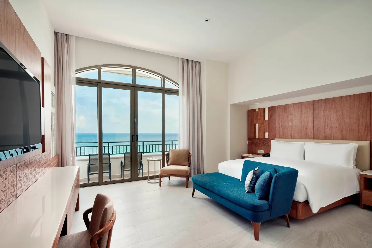 Grand Ocean Front Suite bedroom with king bed and balcony at JW Marriott Cancun Resort & Spa.