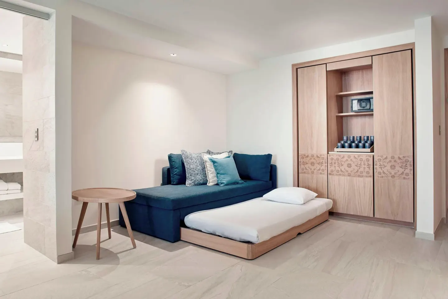 Junior Suite lounge area with sofa bed and wardrobe at JW Marriott Cancun Resort & Spa.