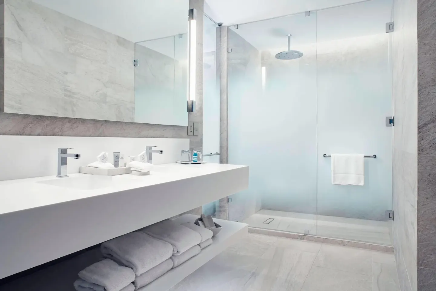 JW Marriott Cancun Resort & Spa bathroom vanity and glass shower at JW Marriott Cancun Resort & Spa.