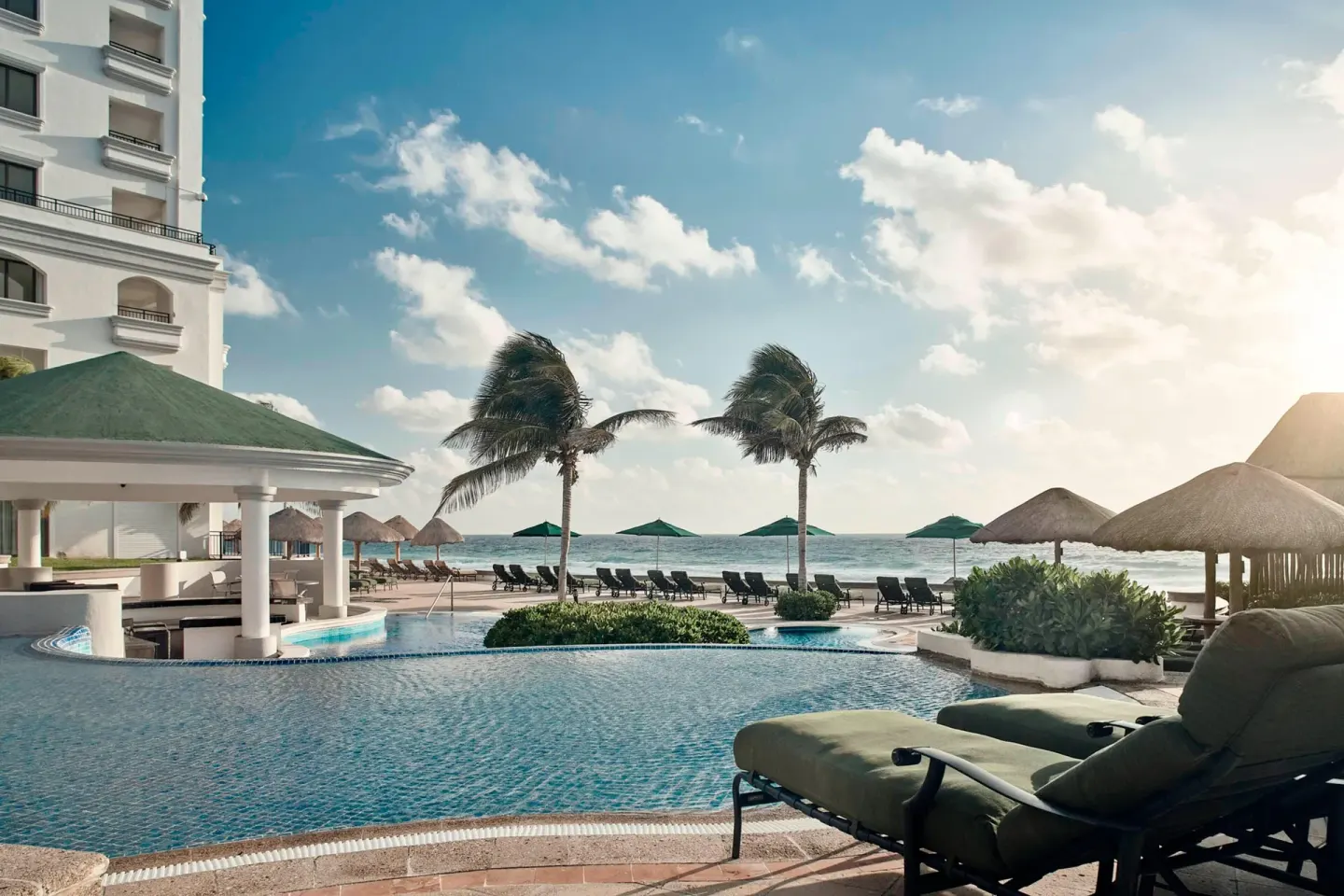Pool and beachfront view from a suite balcony at JW Marriott Cancun Resort & Spa.