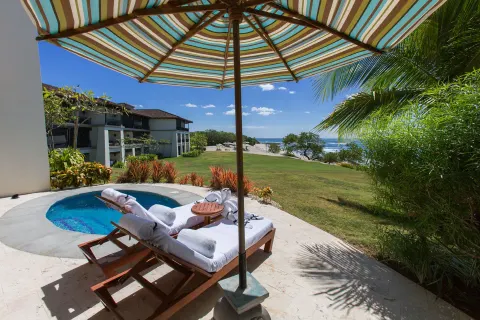 Beachfront plunge pool terrace at JW Marriott Guanacaste Resort and Spa with umbrella loungers and ocean view.
