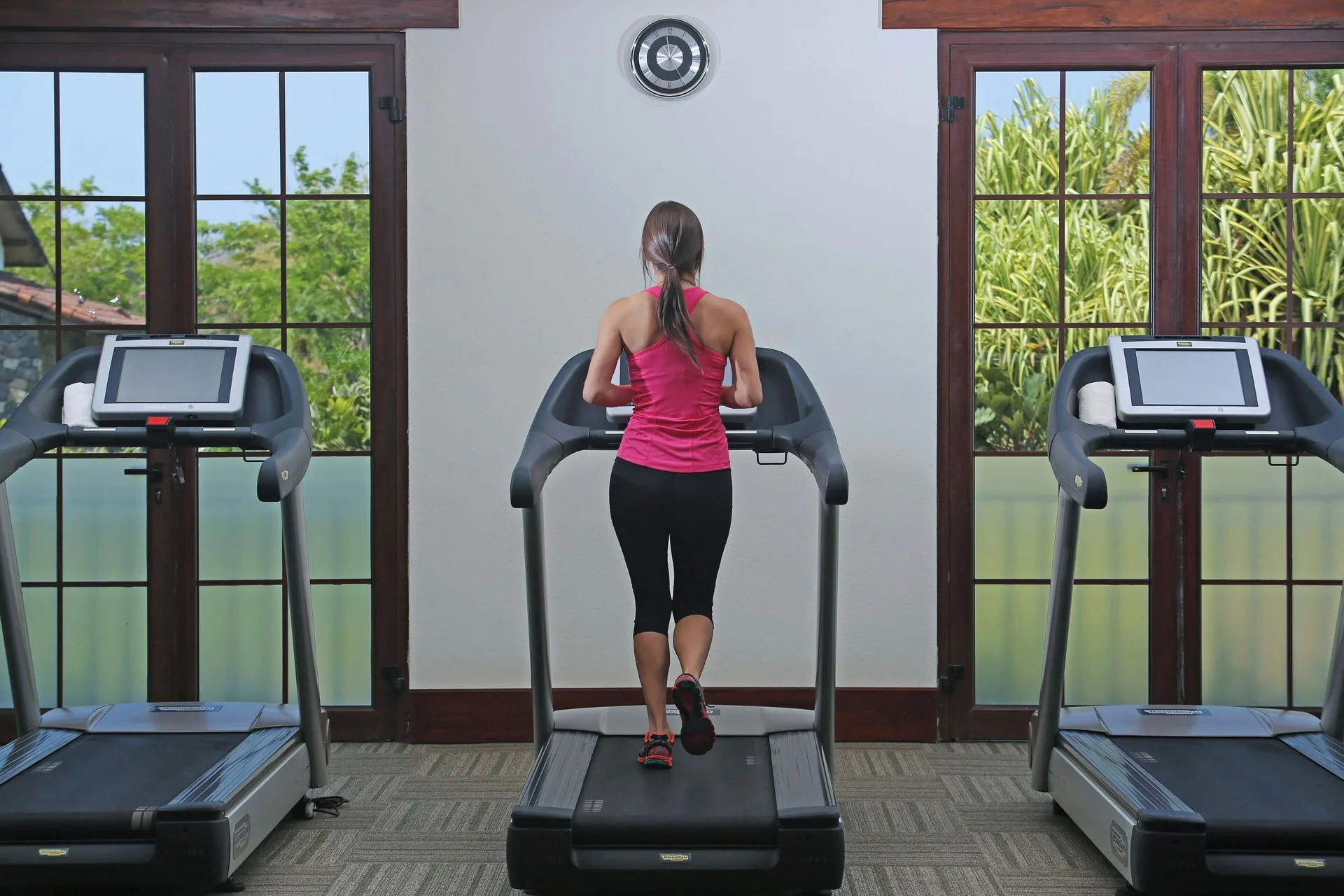Guest using a treadmill in the fitness center at JW Marriott Guanacaste Resort and Spa.