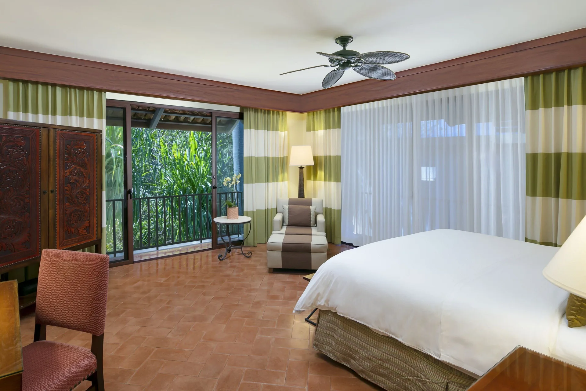 King bed guest room with garden-facing balcony at JW Marriott Guanacaste Resort and Spa.