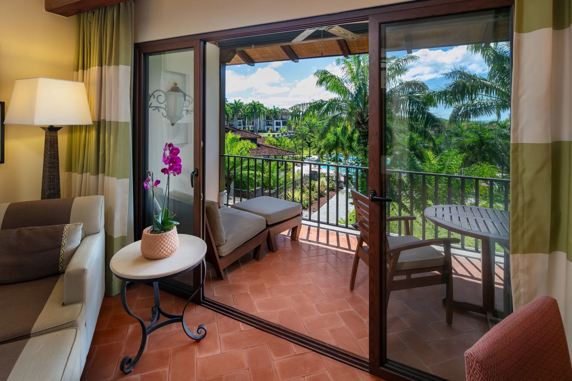 Guest room sitting area opening to a balcony at JW Marriott Guanacaste Resort and Spa.