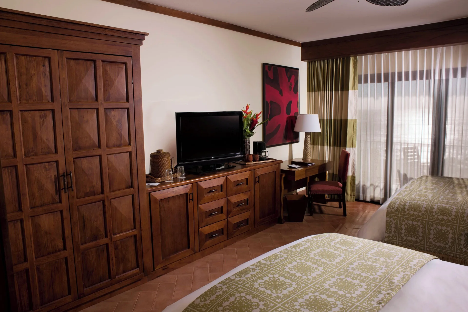 Double bed guest room with wood storage and desk at JW Marriott Guanacaste Resort and Spa.