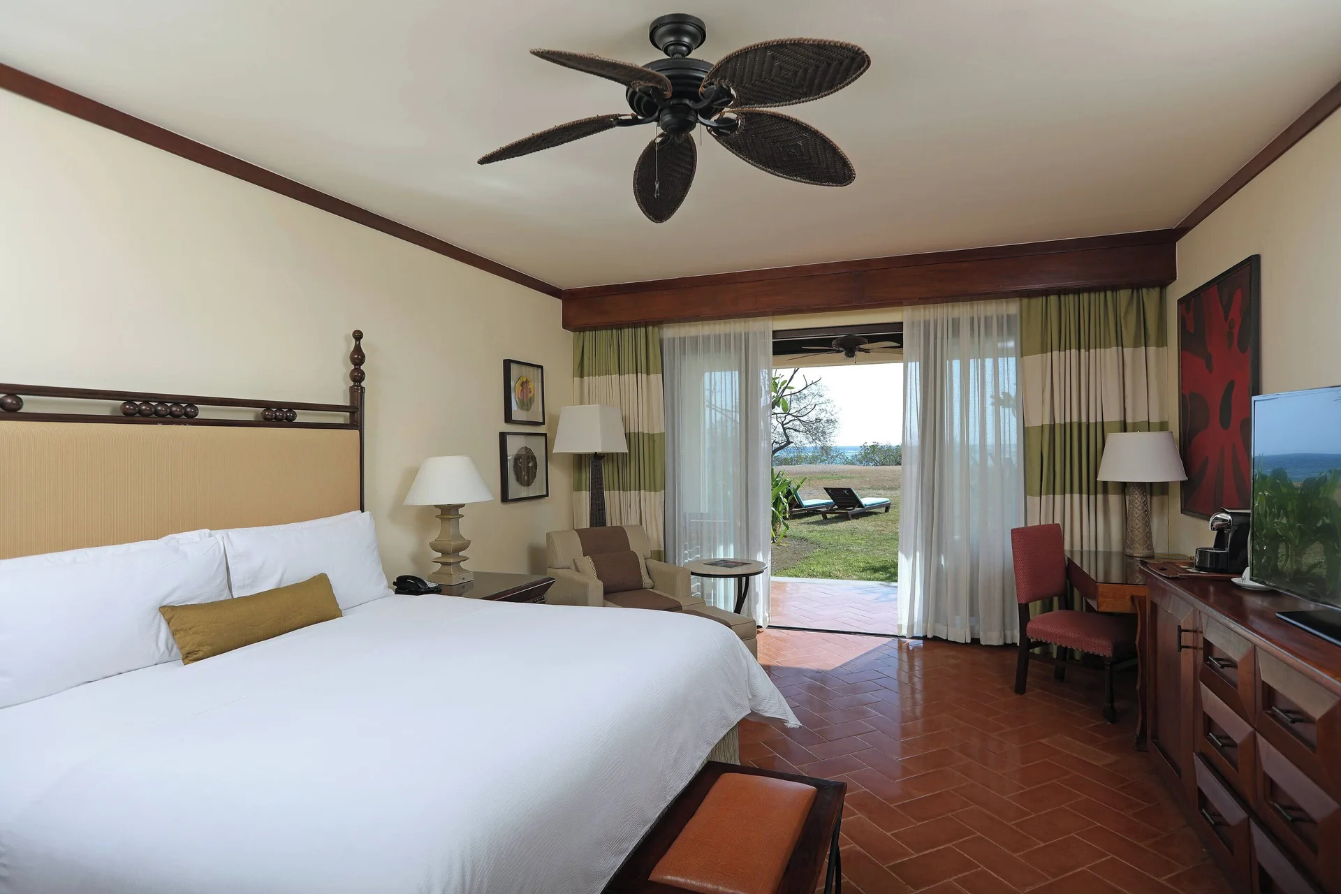 King guest room with patio and ocean glimpse at JW Marriott Guanacaste Resort and Spa.