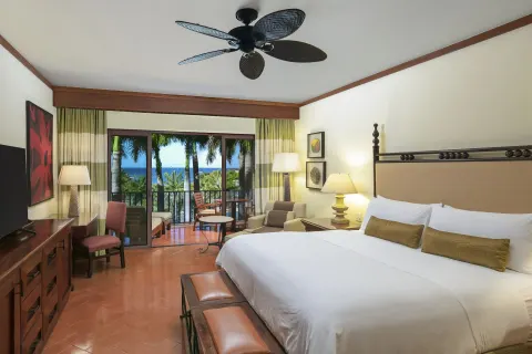 King bed guest room with ocean-facing balcony at JW Marriott Guanacaste Resort and Spa.