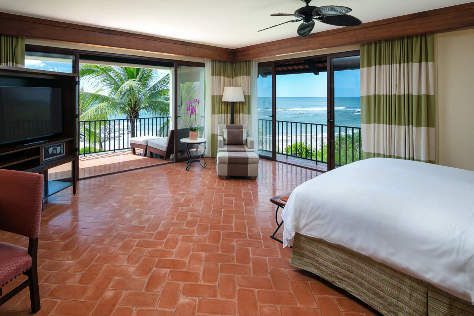 Oceanfront king guest room at JW Marriott Guanacaste Resort and Spa with balcony doors facing the water.
