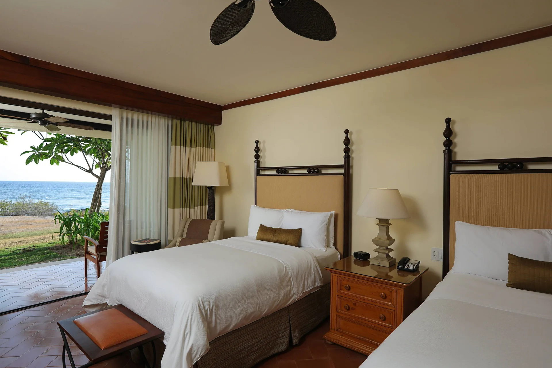 Guest room with two beds and an oceanfront patio at JW Marriott Guanacaste Resort and Spa.