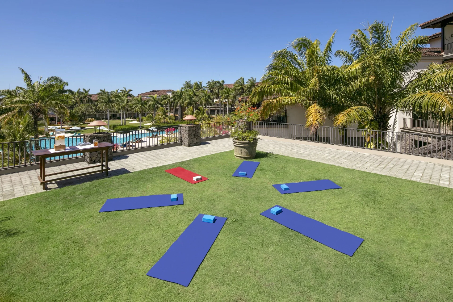 Yoga mats are arranged on a lawn by the pool at JW Marriott Guanacaste Resort and Spa.