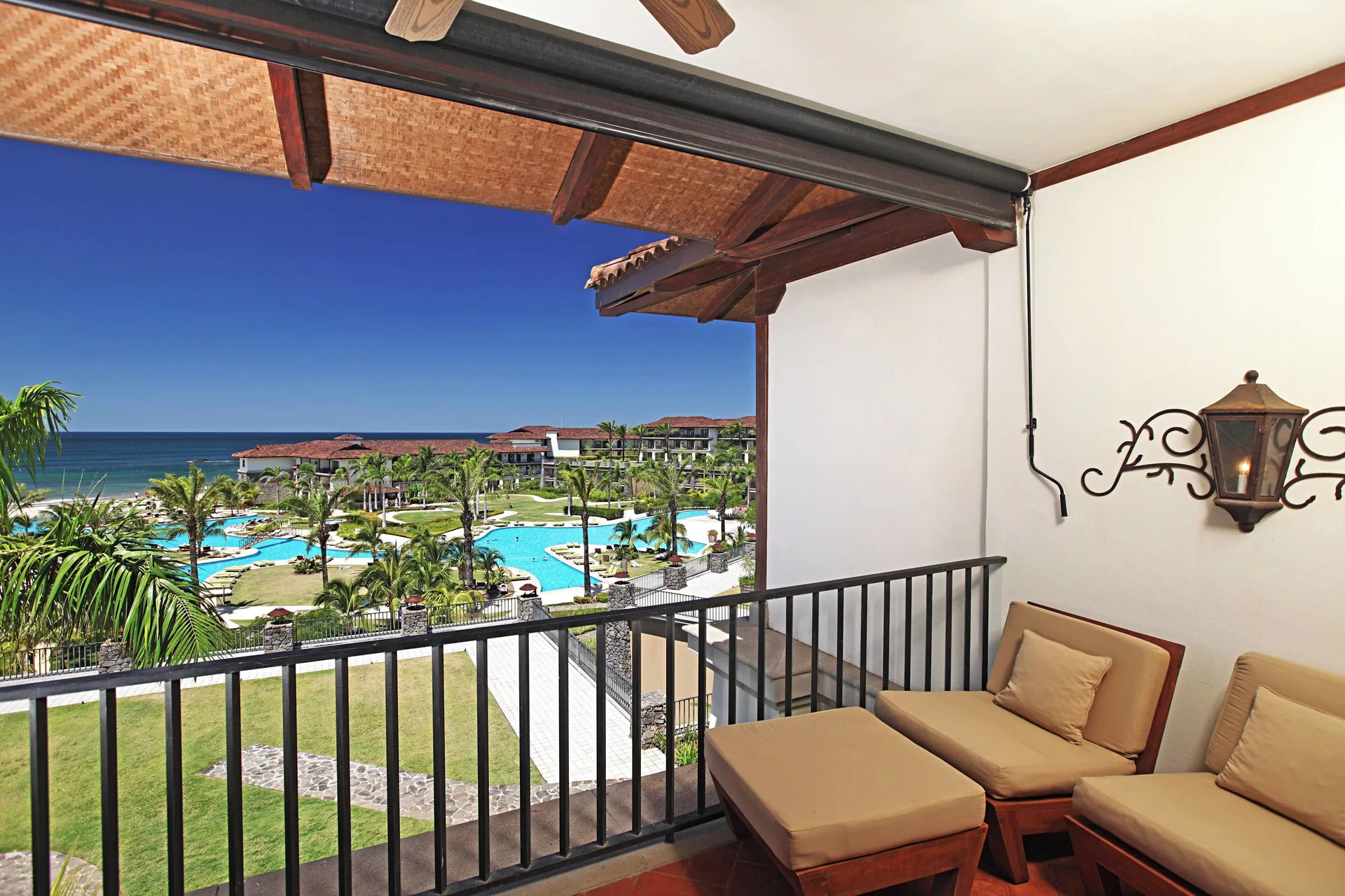 Balcony seating overlooking pools and the ocean at JW Marriott Guanacaste Resort and Spa.