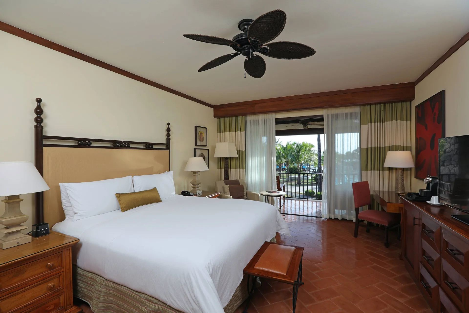 King guest room with balcony and palm view at JW Marriott Guanacaste Resort and Spa.