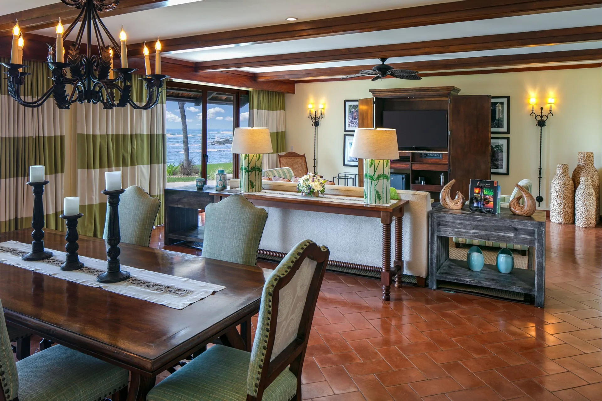 Suite living and dining area at JW Marriott Guanacaste Resort and Spa with ocean visible through large windows.