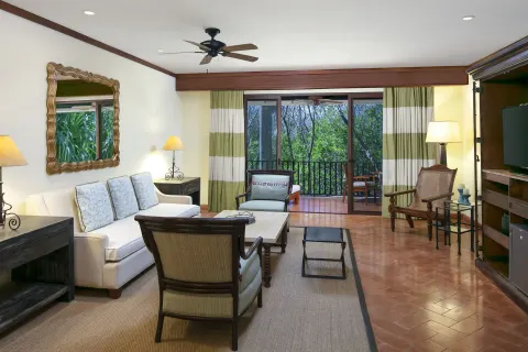 Suite living room with sofa and balcony at JW Marriott Guanacaste Resort and Spa.