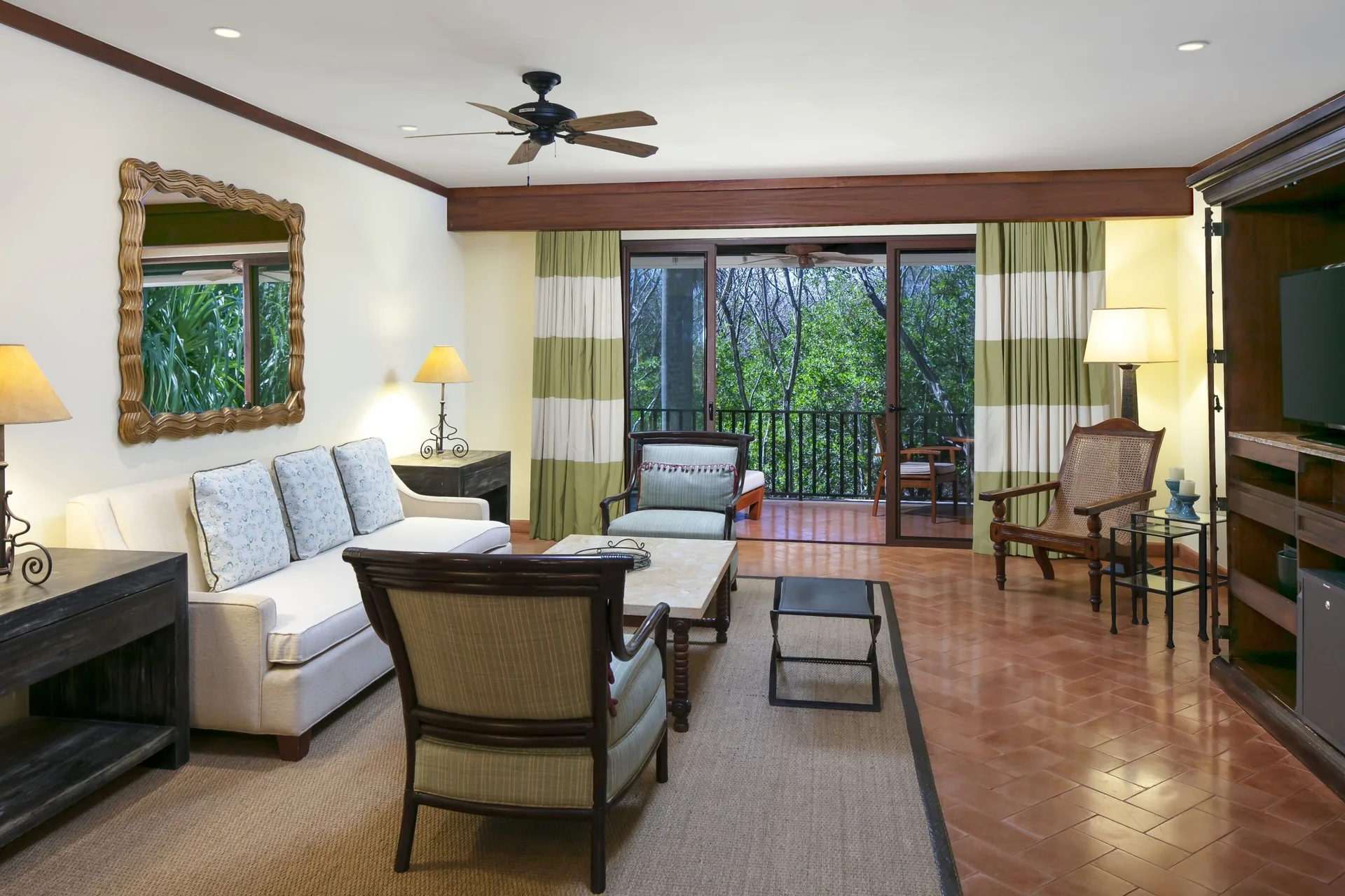 Suite living room with sofa and balcony at JW Marriott Guanacaste Resort and Spa.
