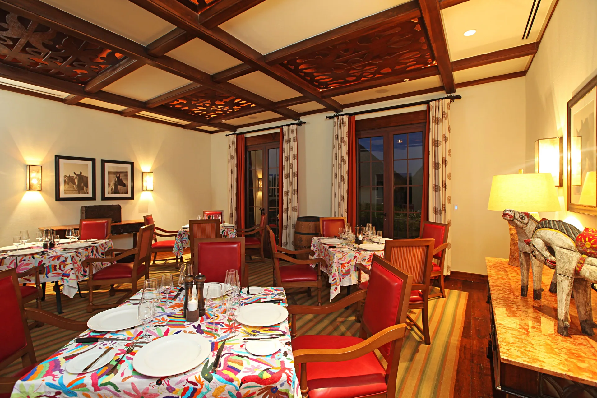 Dining room with red chairs and patterned tables at JW Marriott Guanacaste Resort and Spa.
