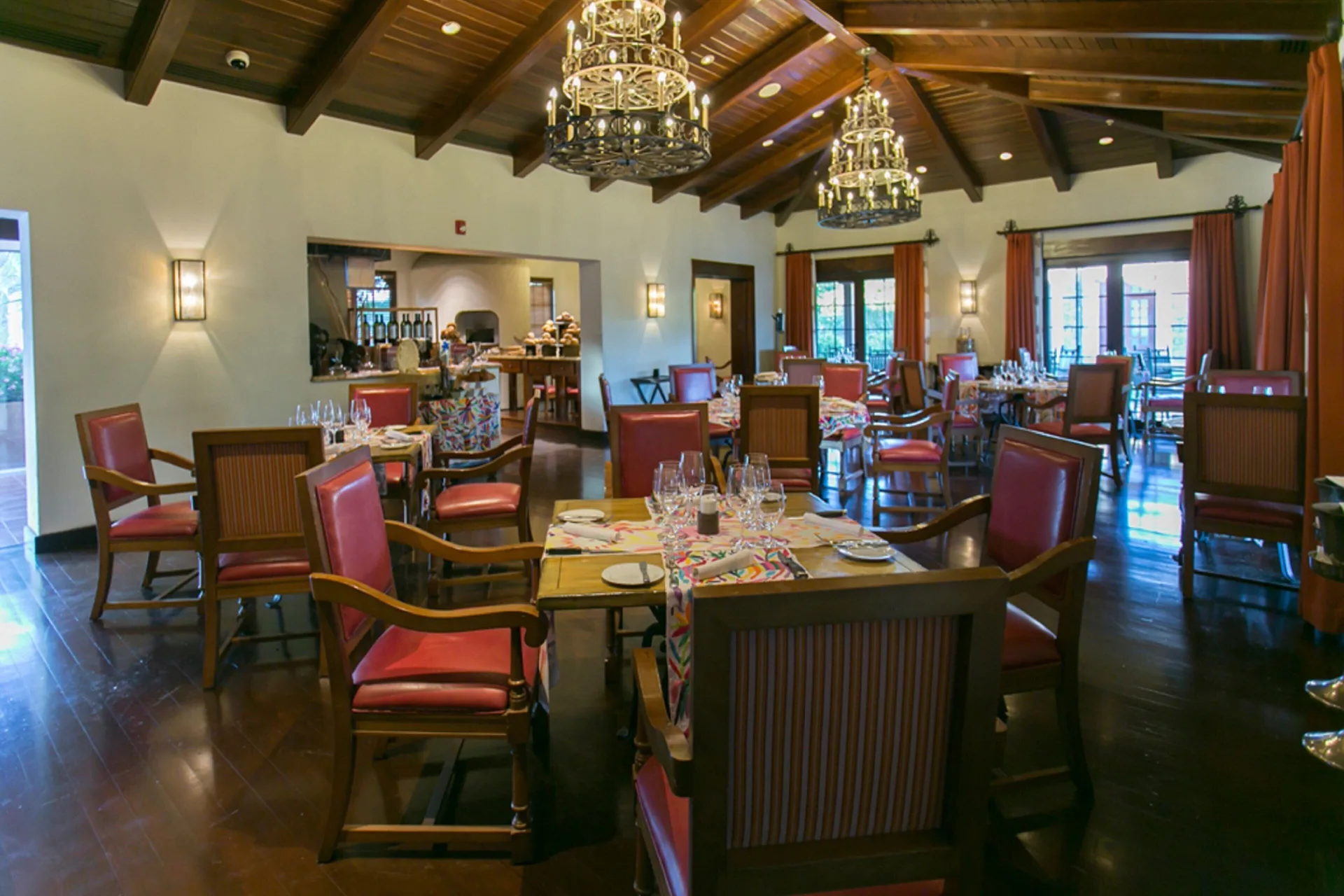 Indoor steakhouse dining room with red chairs at JW Marriott Guanacaste Resort and Spa.