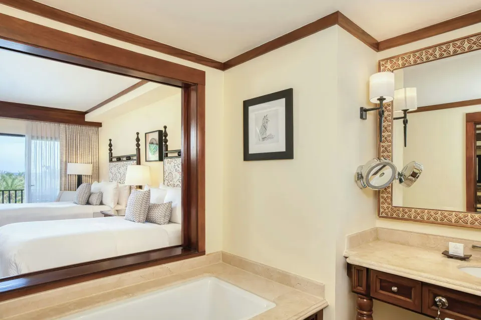 Deluxe Room bath with tub and two beds beyond at JW Marriott Guanacaste Resort and Spa.