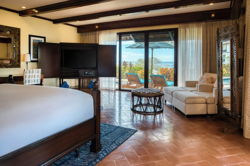 Suite king bedroom with private balcony at JW Marriott Guanacaste Resort and Spa.