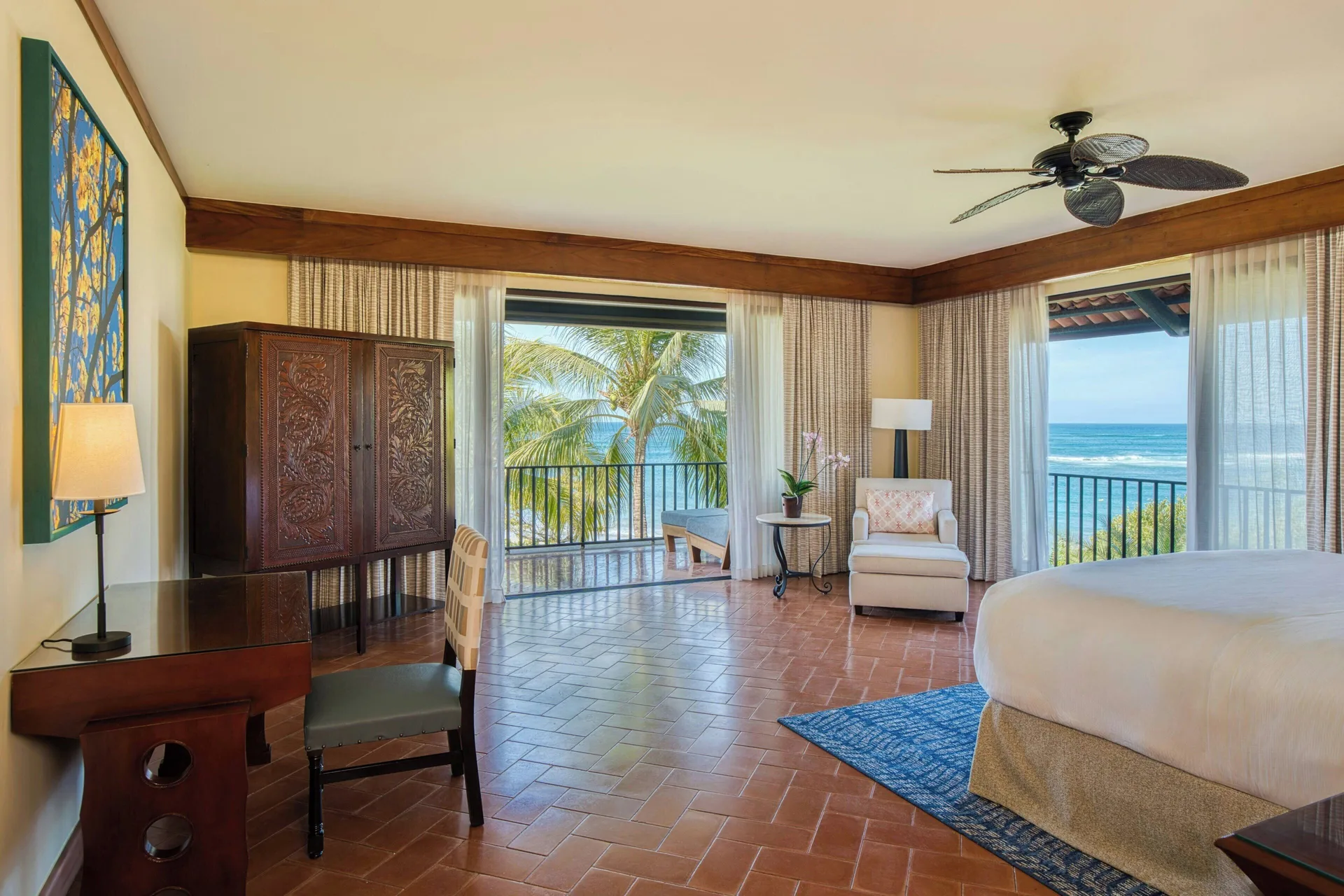 Oceanfront suite bedroom with king bed and balcony at JW Marriott Guanacaste Resort and Spa.