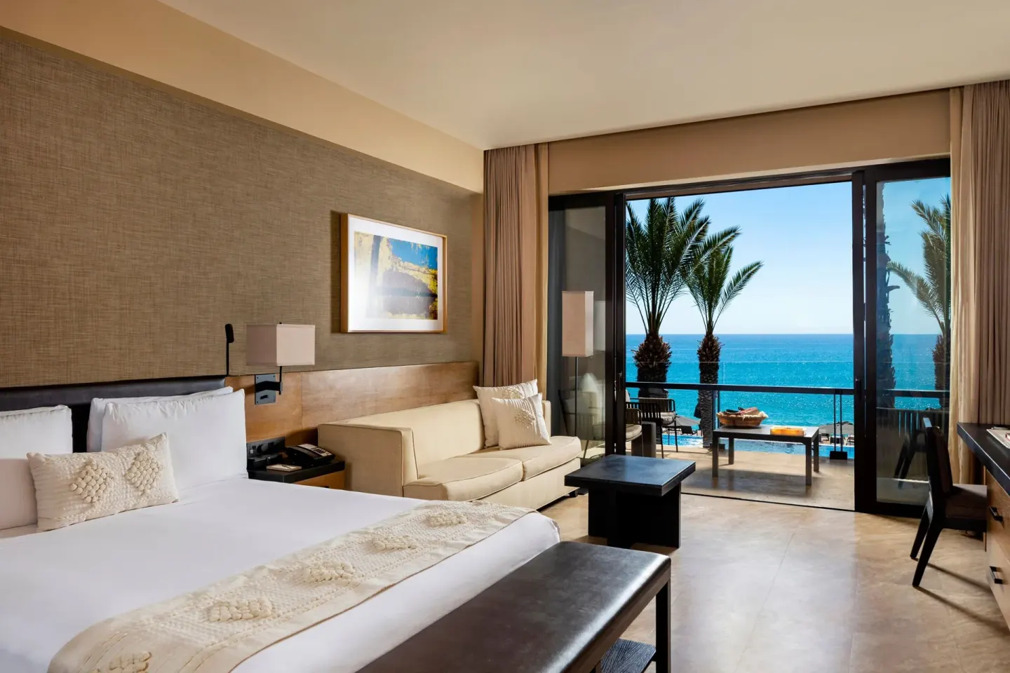 Ocean-view king guest room with balcony at JW Marriott Los Cabos Beach Resort & Spa.