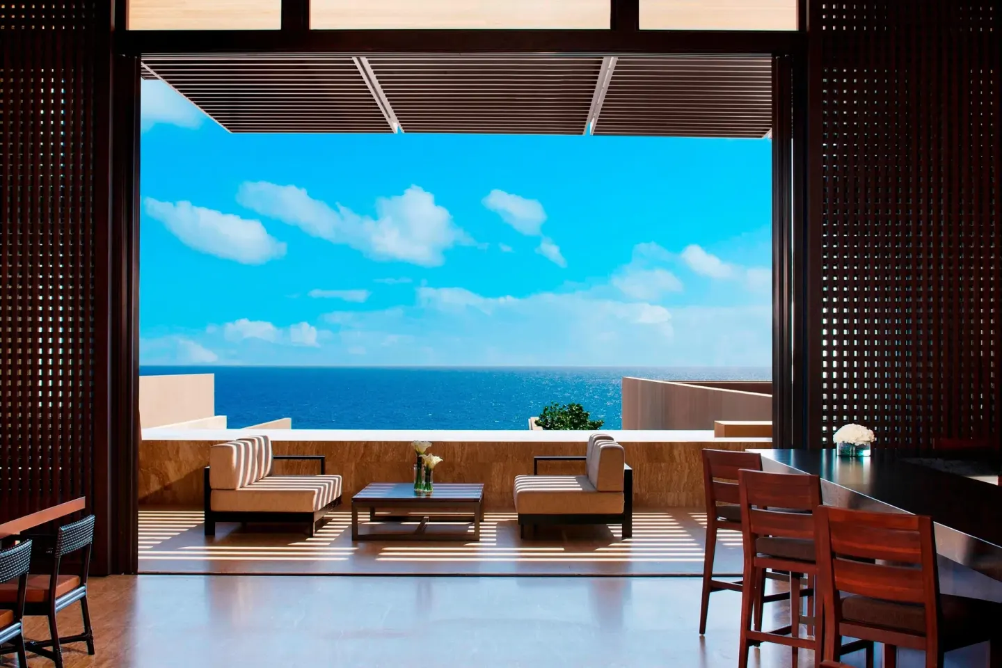 Open indoor lounge and terrace with ocean view at JW Marriott Los Cabos Beach Resort & Spa.