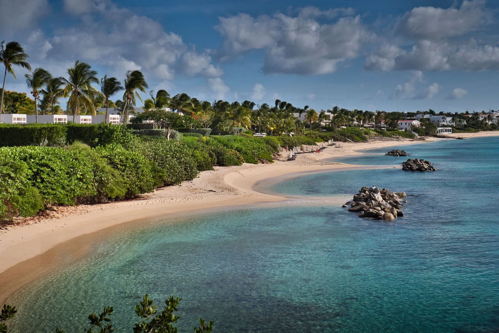 Curving beach and turquoise water near JW Marriott St. Maarten Beach Resort & Spa.
