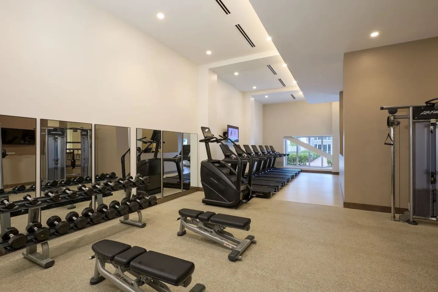 Fitness center with treadmills, dumbbells, and benches at JW Marriott St. Maarten Beach Resort & Spa.