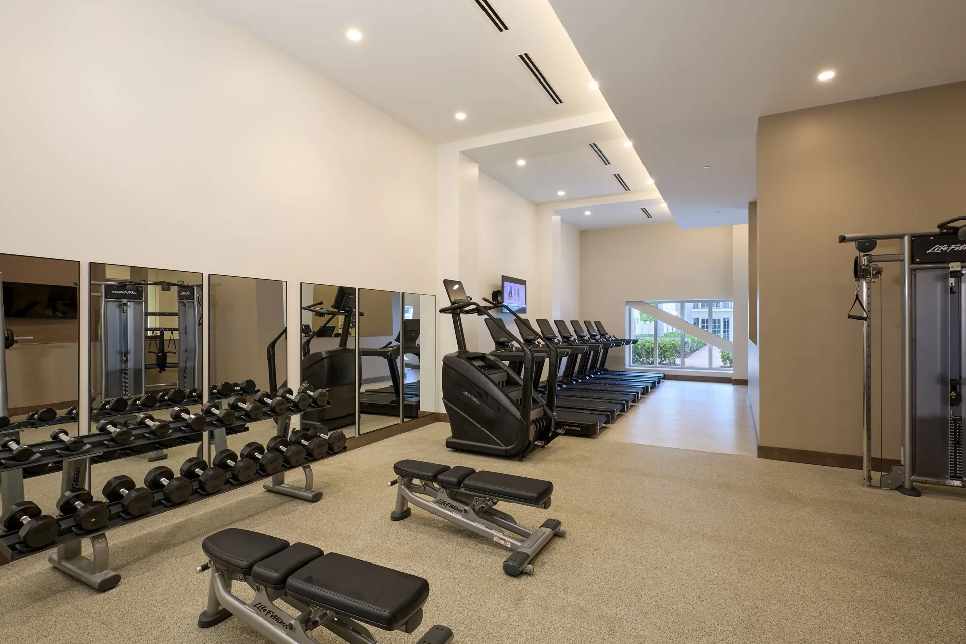 Fitness center with treadmills, dumbbells, and benches at JW Marriott St. Maarten Beach Resort & Spa.