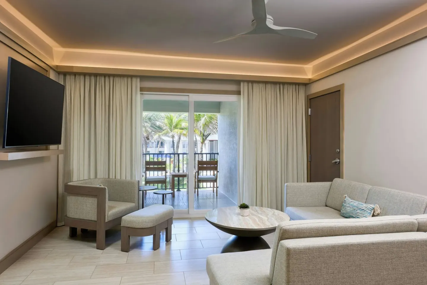 Guest room sitting area with balcony at JW Marriott St. Maarten Beach Resort & Spa.