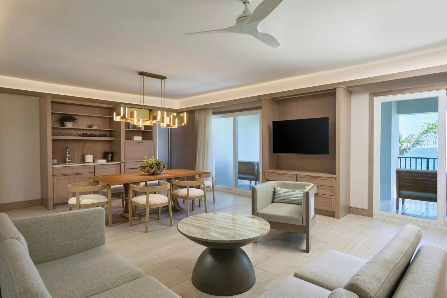 Large suite living room with dining table and two balconies at JW Marriott St. Maarten Beach Resort & Spa.