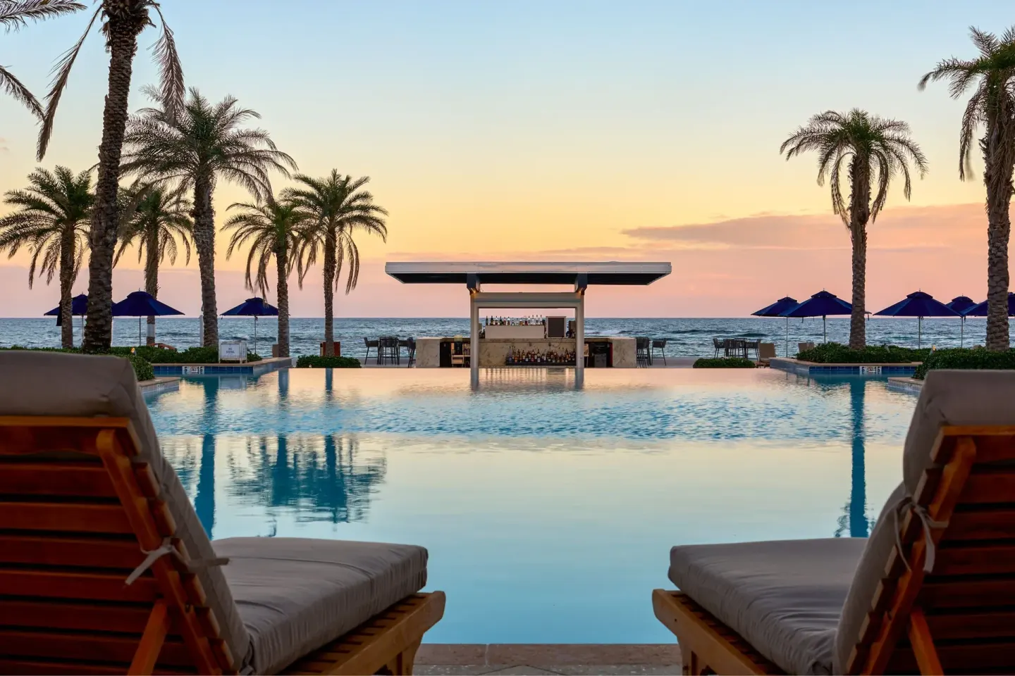 Oceanfront pool with loungers and a swim-up bar at JW Marriott St. Maarten Beach Resort & Spa.