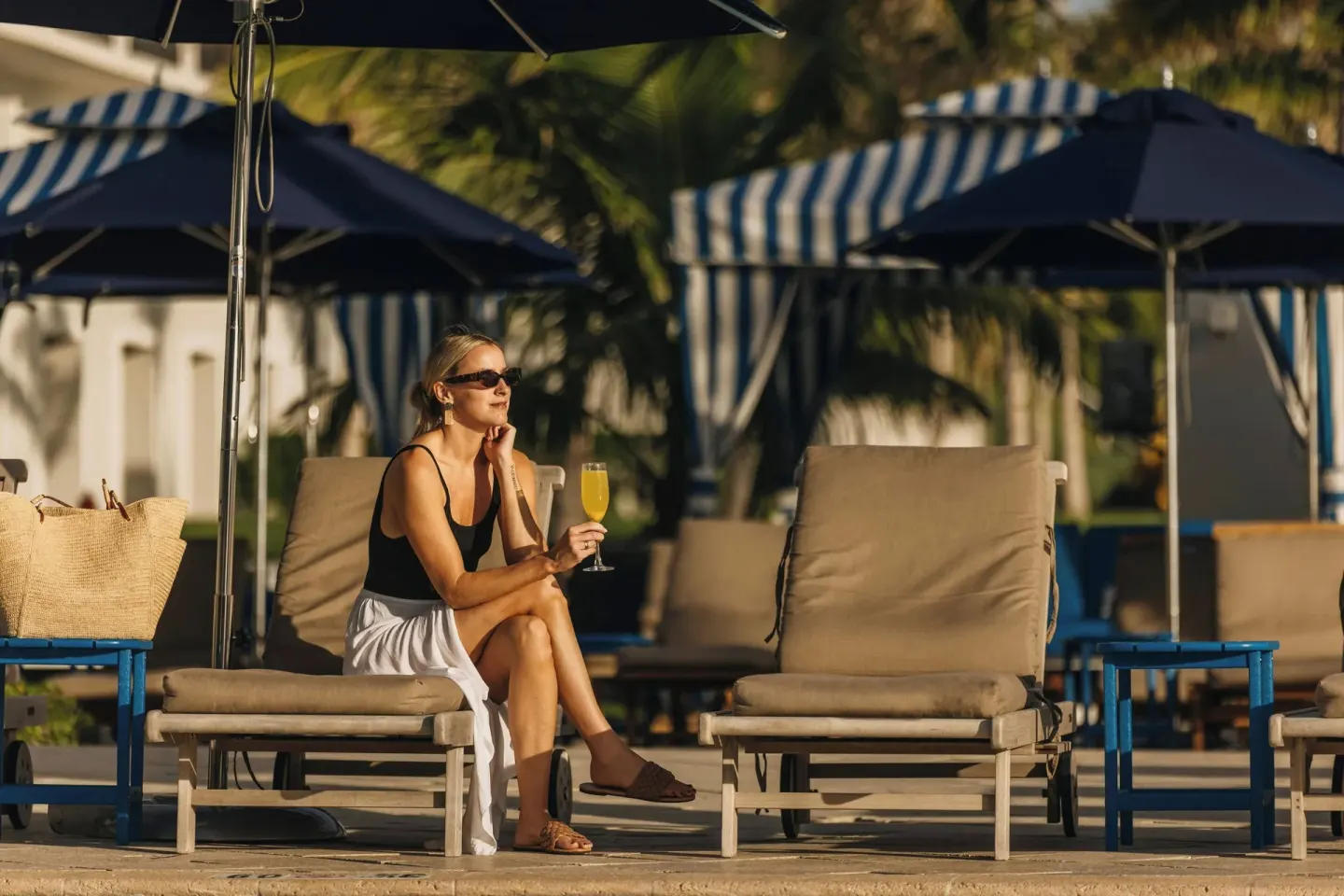 Guest relaxing on a pool lounger at JW Marriott St. Maarten Beach Resort & Spa.