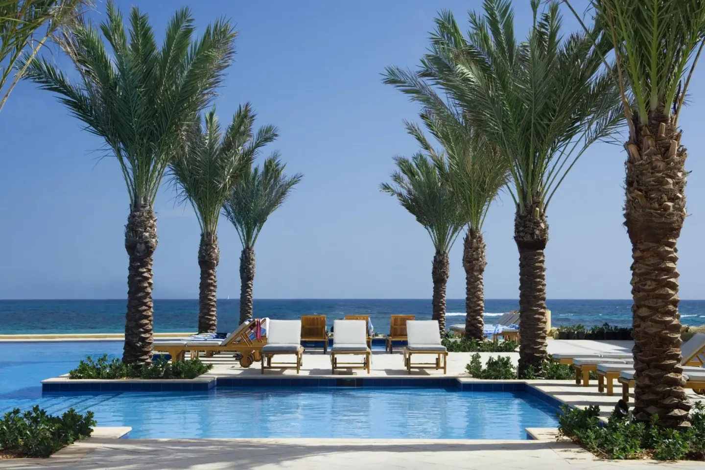 Poolside loungers facing the ocean at JW Marriott St. Maarten Beach Resort & Spa.