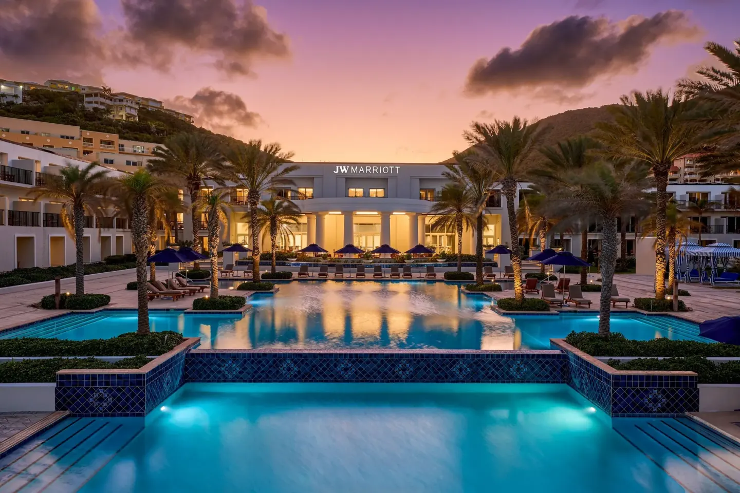 Twilight pool courtyard with palms at JW Marriott St. Maarten Beach Resort & Spa.