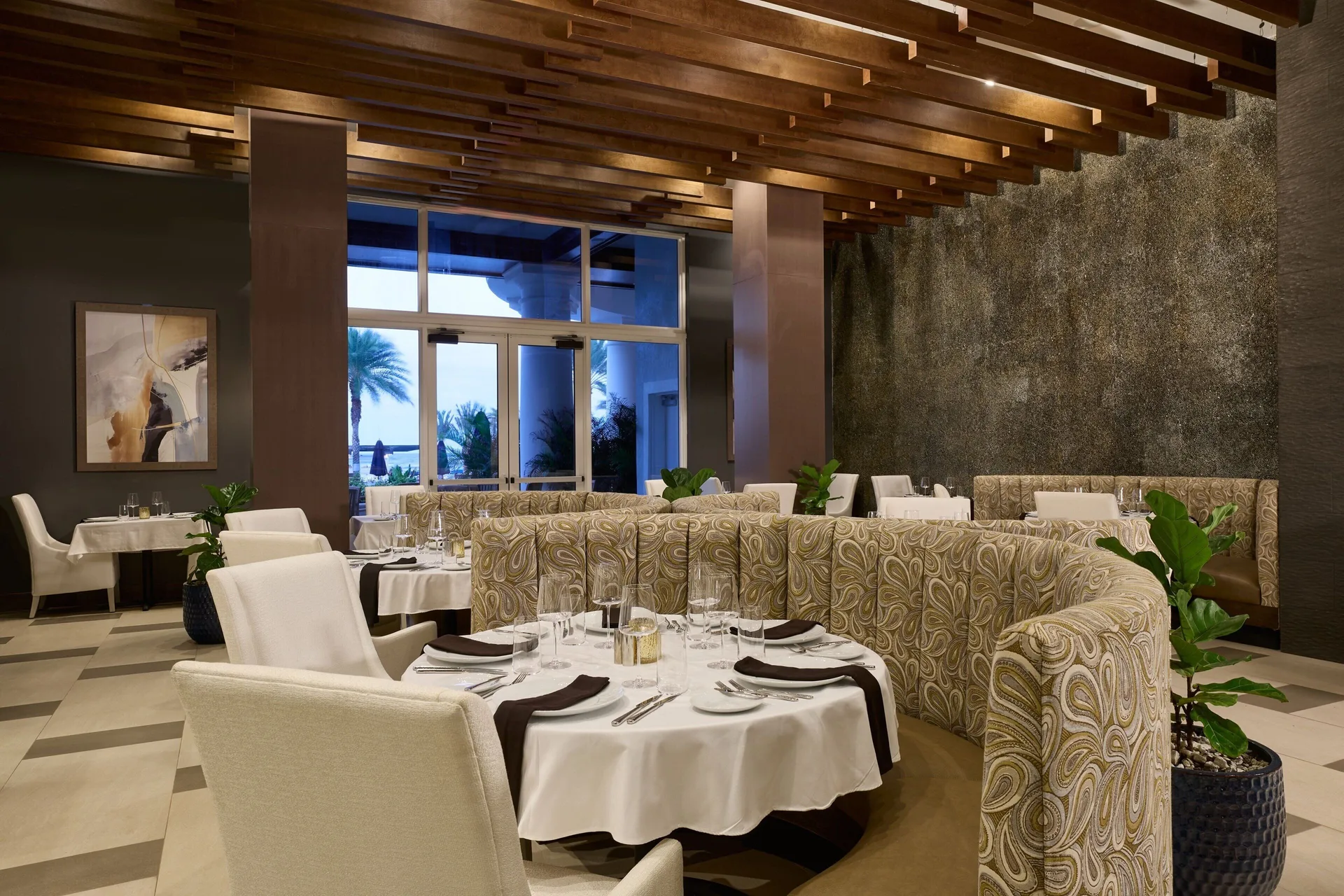 Elegant dining room with round tables at JW Marriott St. Maarten Beach Resort & Spa.