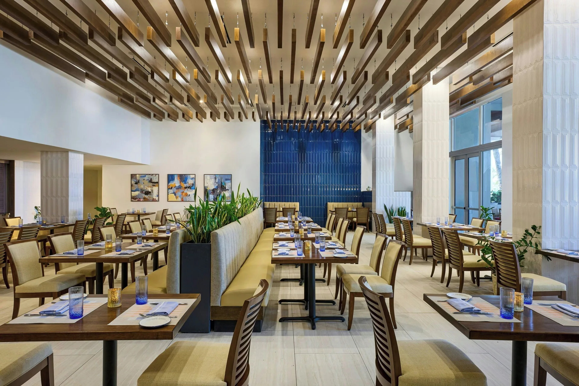 Large restaurant dining room with wood ceiling slats at JW Marriott St. Maarten Beach Resort & Spa.