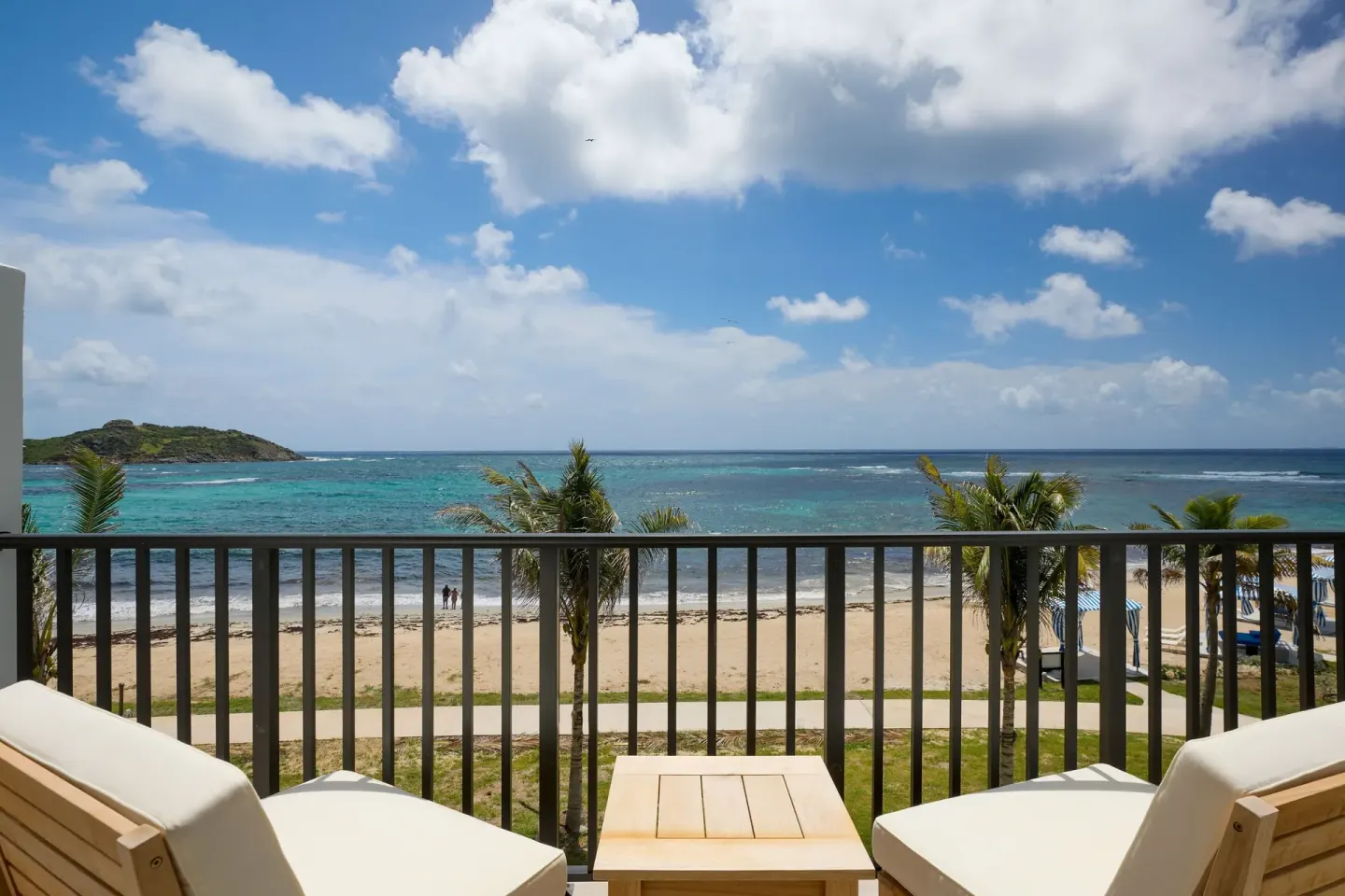 Balcony chairs overlooking the beach and ocean at JW Marriott St. Maarten Beach Resort & Spa.