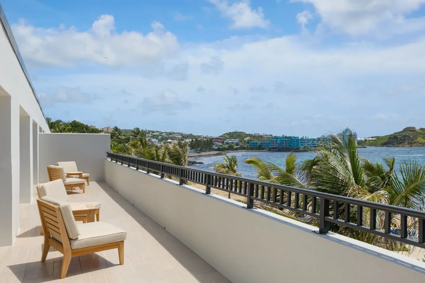 Long oceanfront balcony with lounge chairs at JW Marriott St. Maarten Beach Resort & Spa.