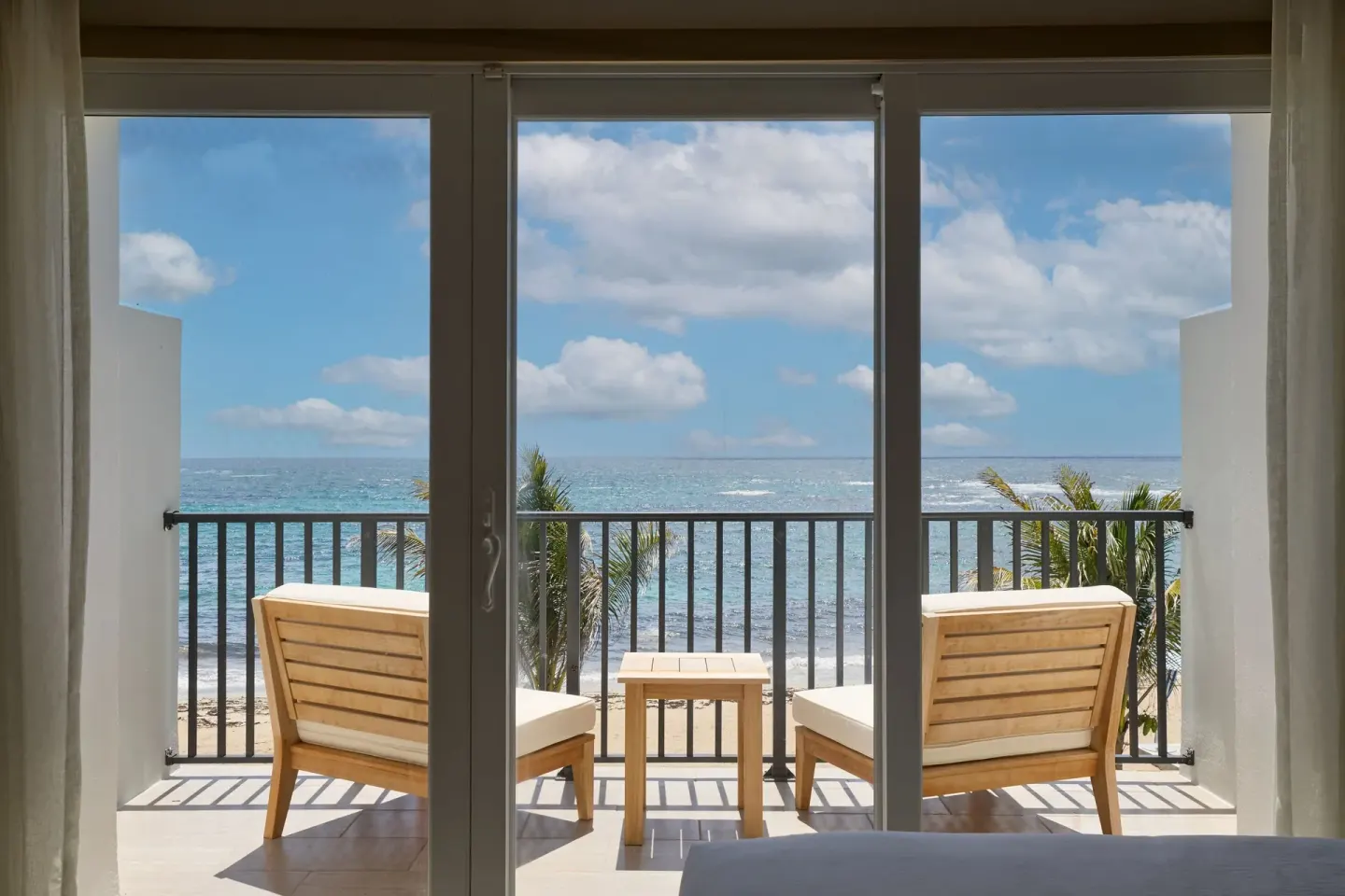 Oceanfront balcony seen through room doors at JW Marriott St. Maarten Beach Resort & Spa.