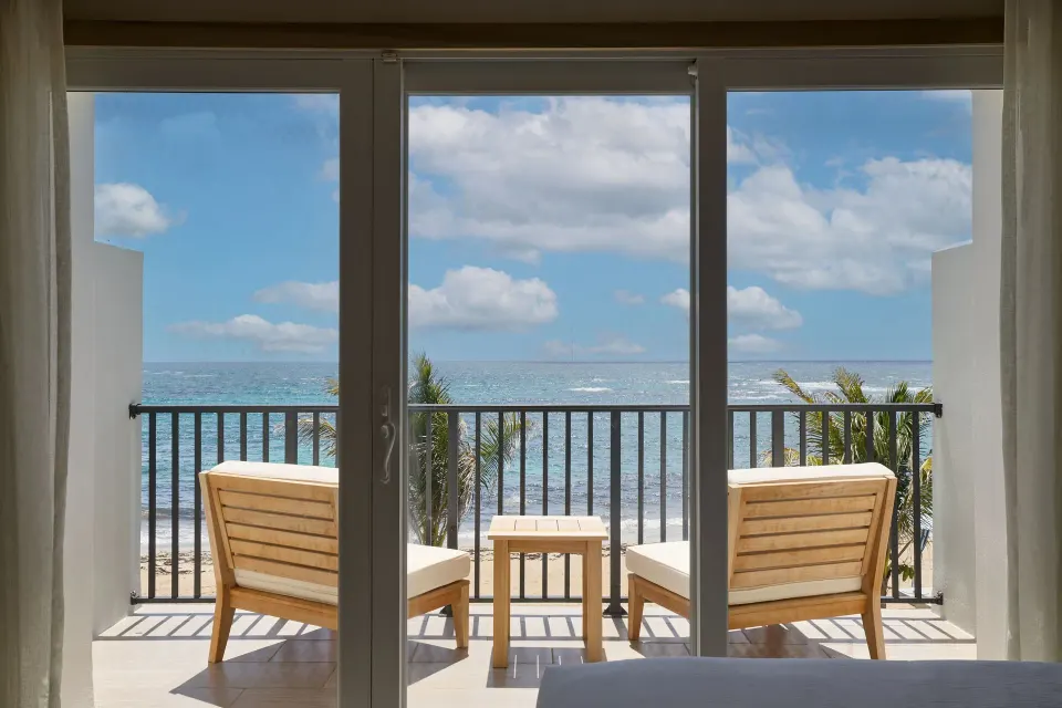 Oceanfront balcony seen through room doors at JW Marriott St. Maarten Beach Resort & Spa.