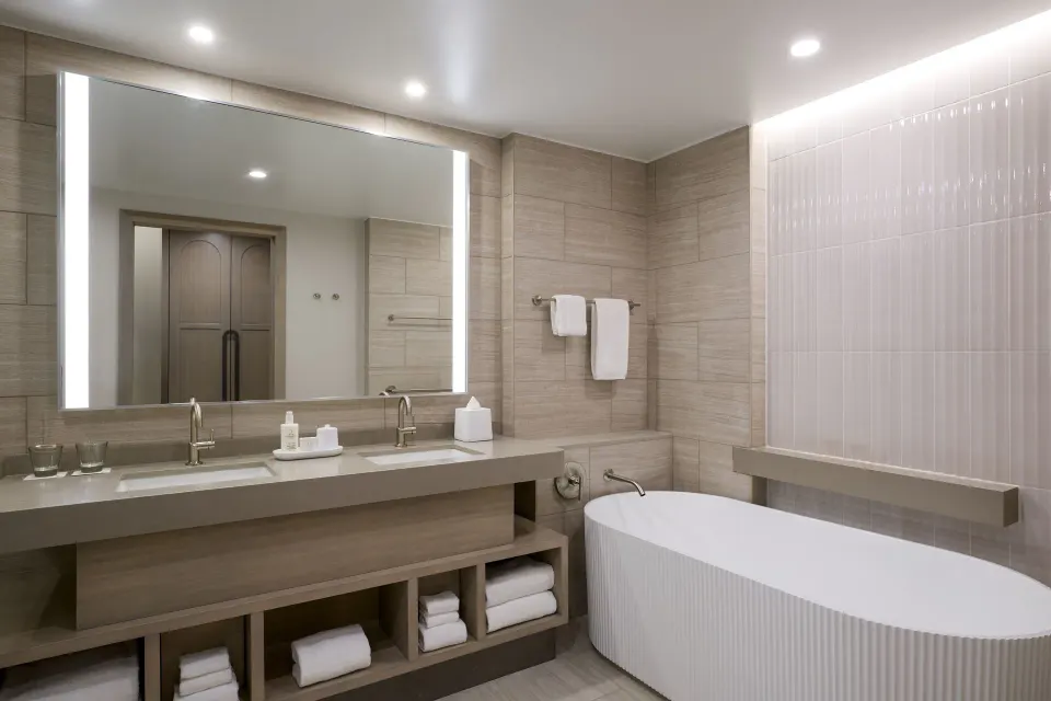 Deluxe Room bathroom with double vanity and bathtub at JW Marriott St. Maarten Beach Resort & Spa.
