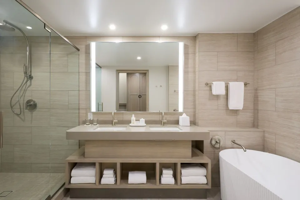 Bathroom with glass shower, double vanity and tub at JW Marriott St. Maarten Beach Resort & Spa.