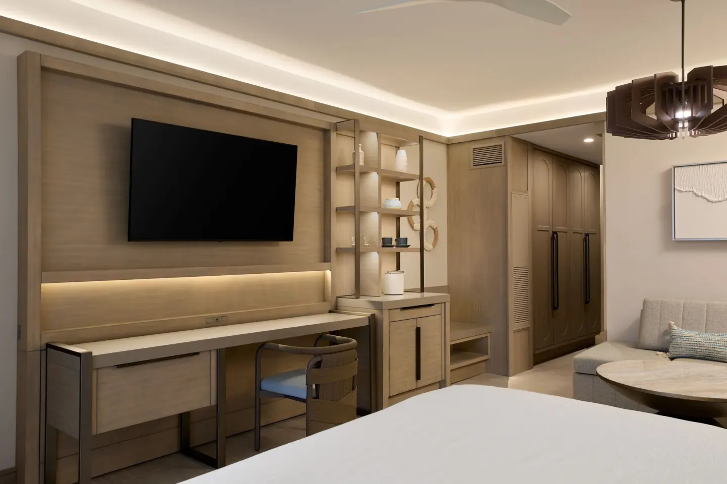 Deluxe Room seating, desk, TV and bed at JW Marriott St. Maarten Beach Resort & Spa.