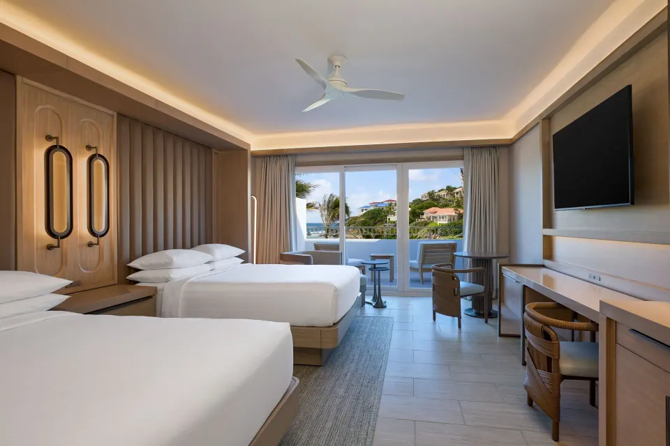 Deluxe Room with two double beds, desk and balcony at JW Marriott St. Maarten Beach Resort & Spa.