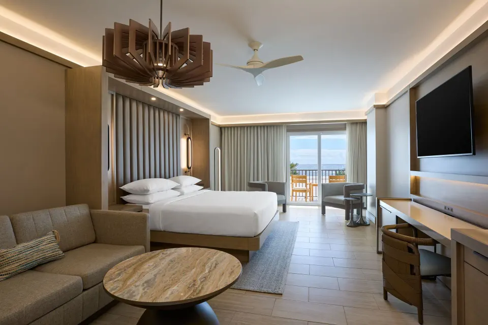 Deluxe oceanfront room with bed, sofa bed and balcony at JW Marriott St. Maarten Beach Resort & Spa.