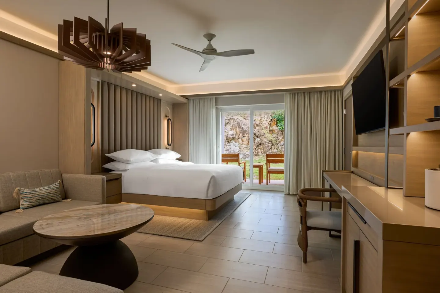 Deluxe room with king bed, sofa bed, desk, and balcony at JW Marriott St. Maarten Beach Resort & Spa.