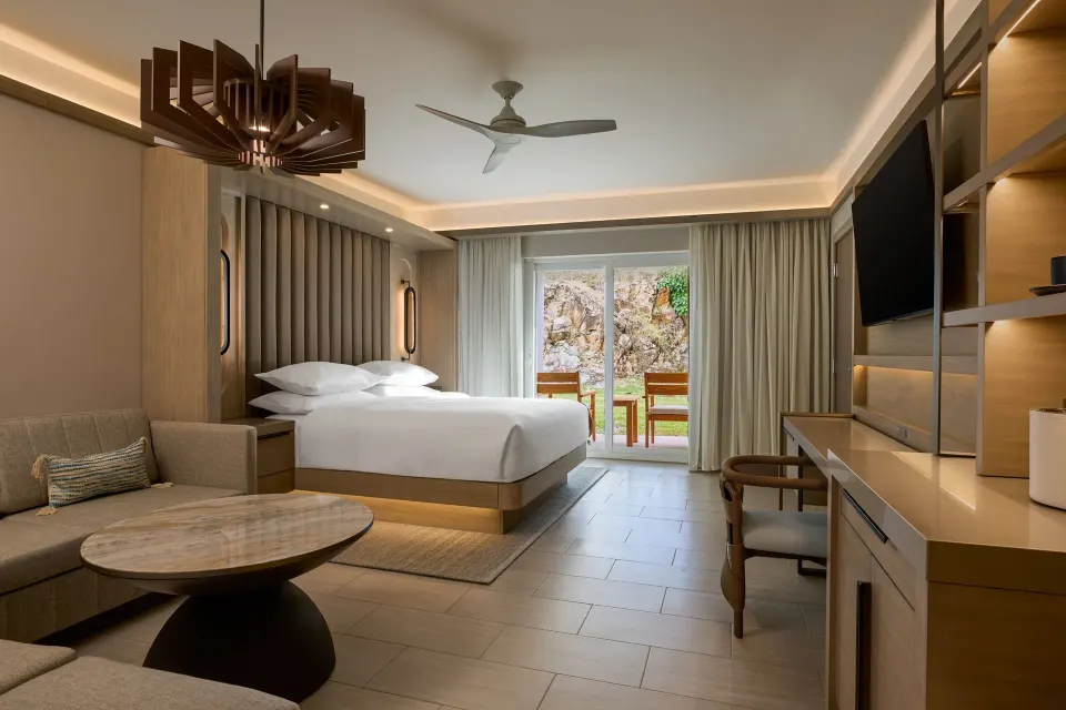 Deluxe room with king bed, sofa bed, desk, and balcony at JW Marriott St. Maarten Beach Resort & Spa.