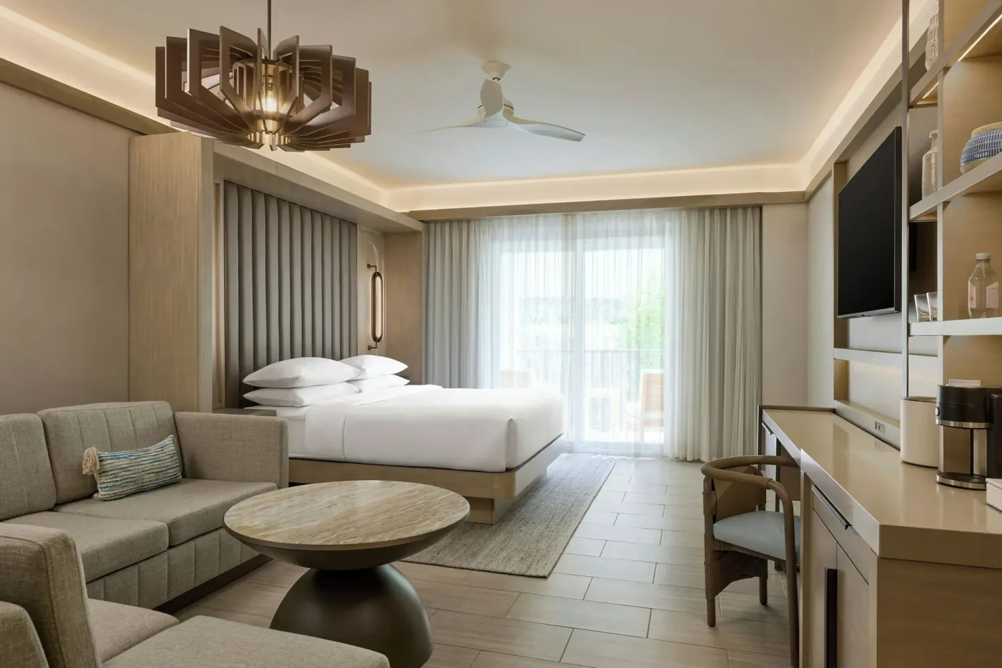 Deluxe room king bed, sofa bed, and media wall at JW Marriott St. Maarten Beach Resort & Spa.