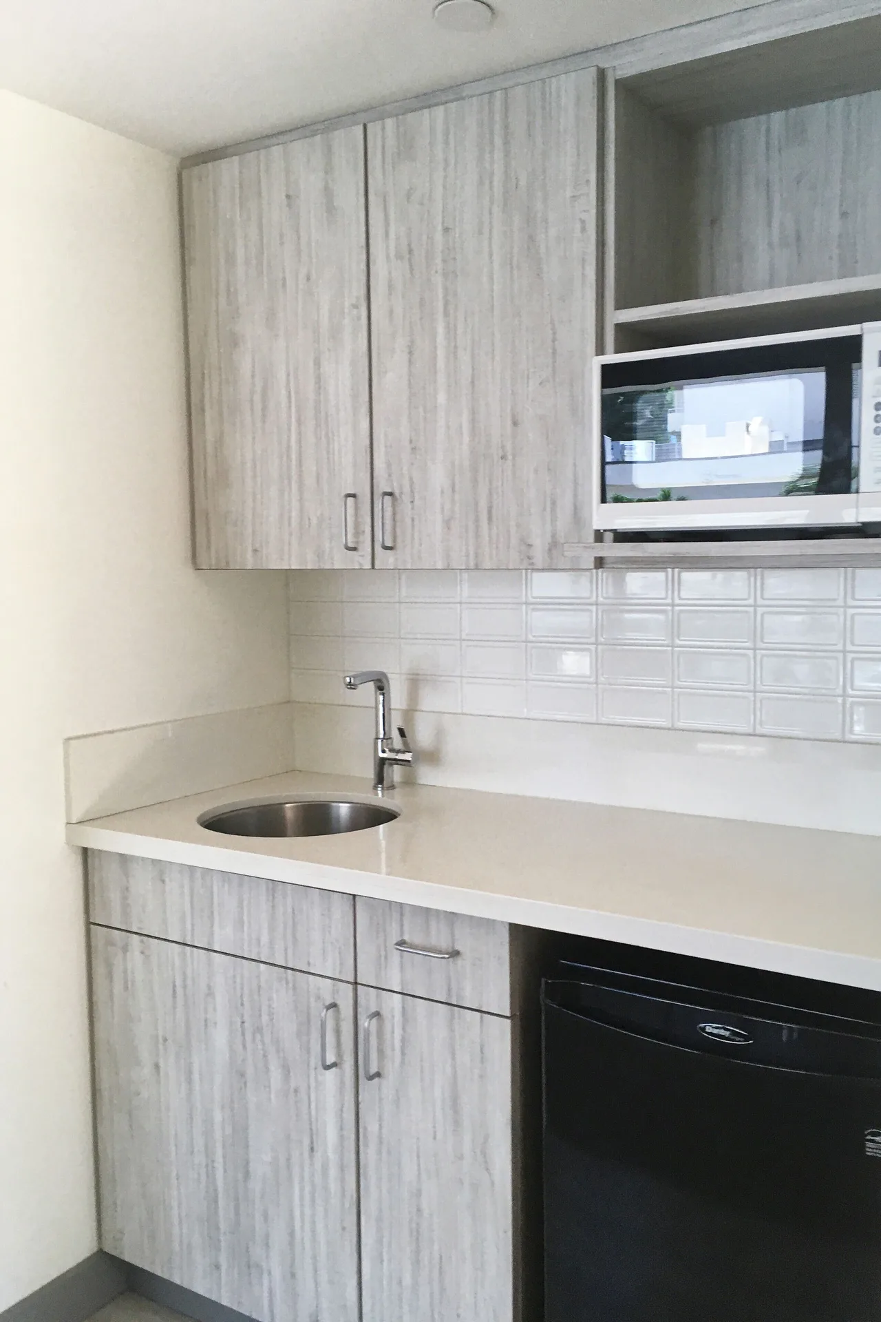 Classic Suite kitchenette with sink, microwave and mini fridge at Kaimana Beach Hotel.